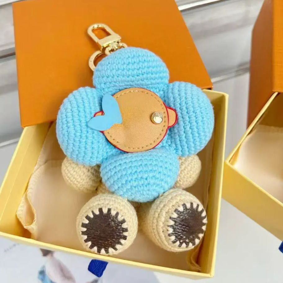 Newest Luxury Bag Charms Designer Weave Sunflower Doll Keychains Woman Mans Purse Charms Key Chain Cartoon Pendant Multi Color Keychain Gift - Image 1